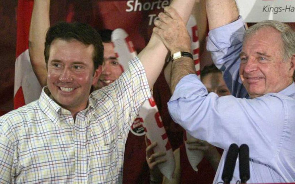 Former prime minister Paul Martin raises the arm of Liberal candidate Scott Brison during a 2004 campaign stop in Windsor. 