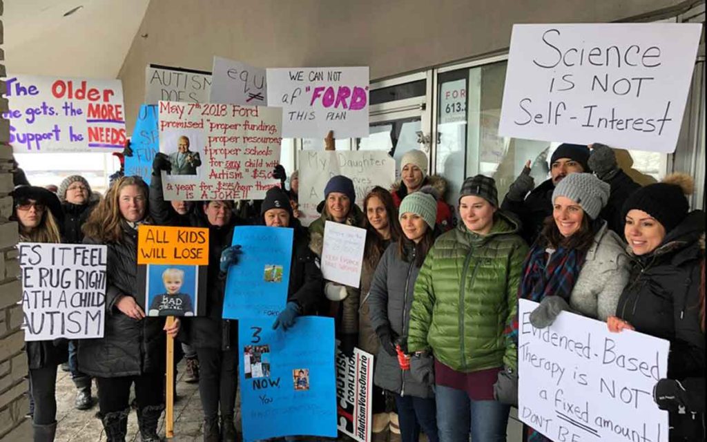Protestors gathered outside MPP Lisa MacLeod's office in Nepean to voice their opposition to the new autism funding plan.