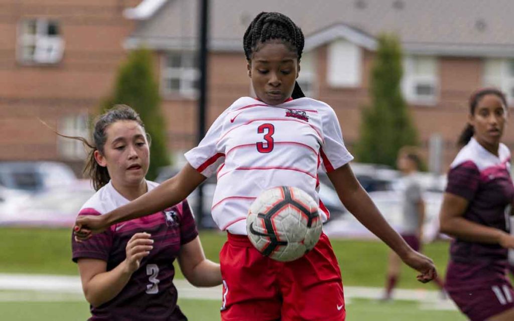 two university students playing soccer