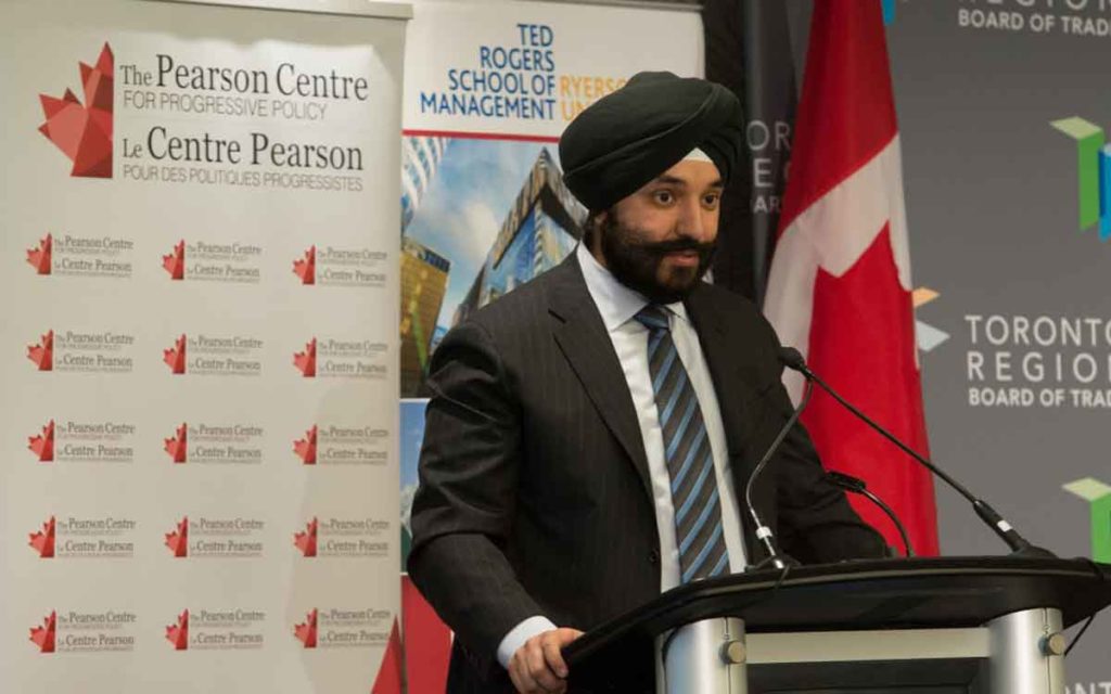 Navdeep Bains stadning at a podium