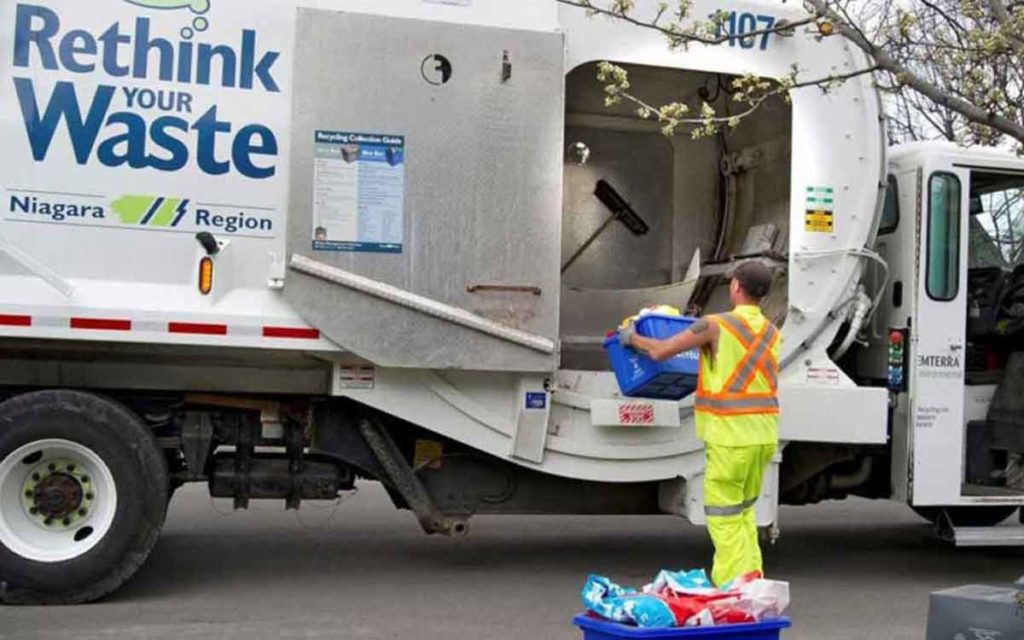 worker picking up recycling