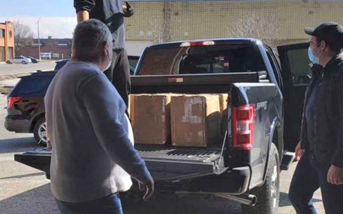 premier ford loading donated face masks into his truck