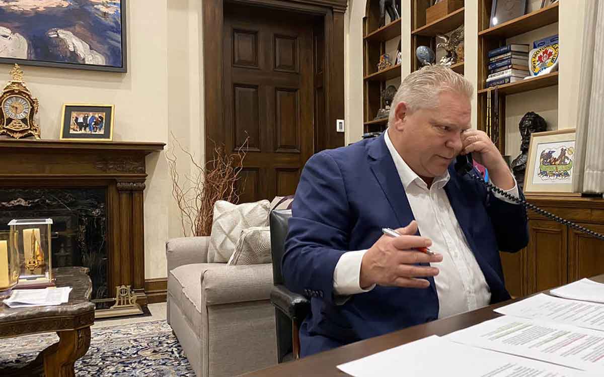 Premier Ford at his desk making phone calls