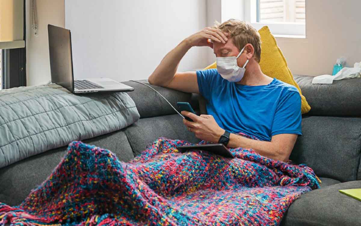 man on couch wearing mask