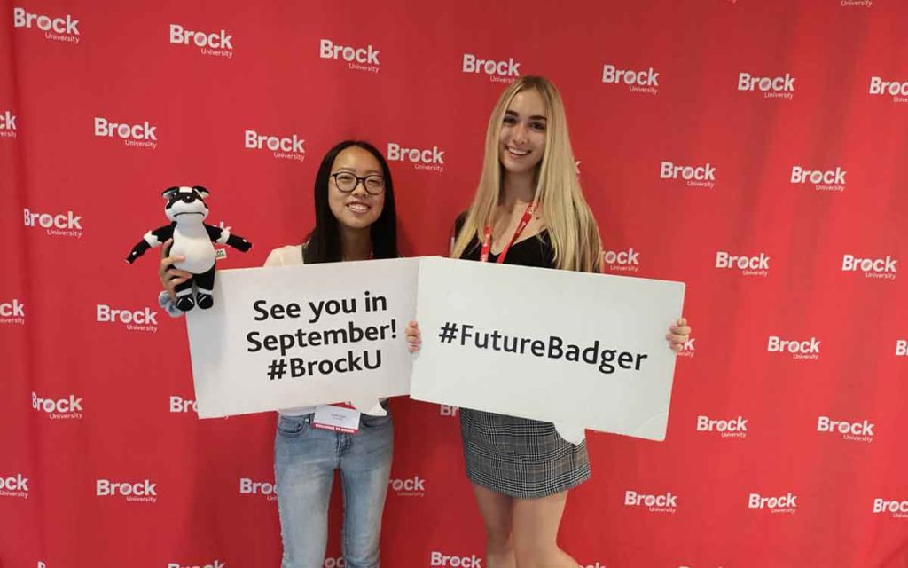 Brock University students holding signs
