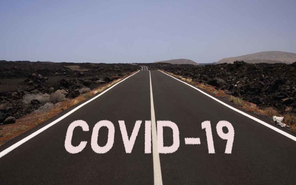 a road with the words "covid-19"