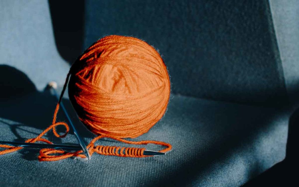 a ball of yarn and knitting needles