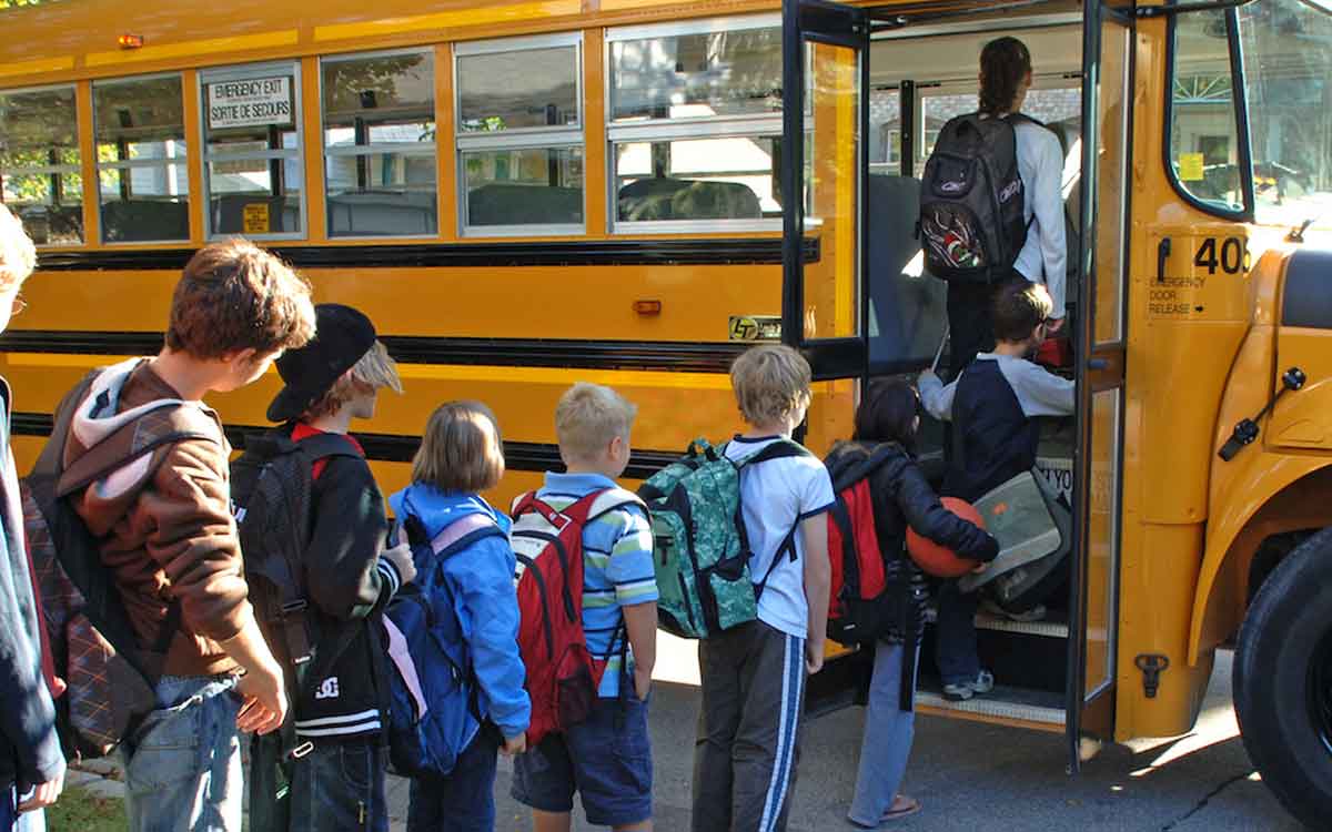 children boarding a school bus