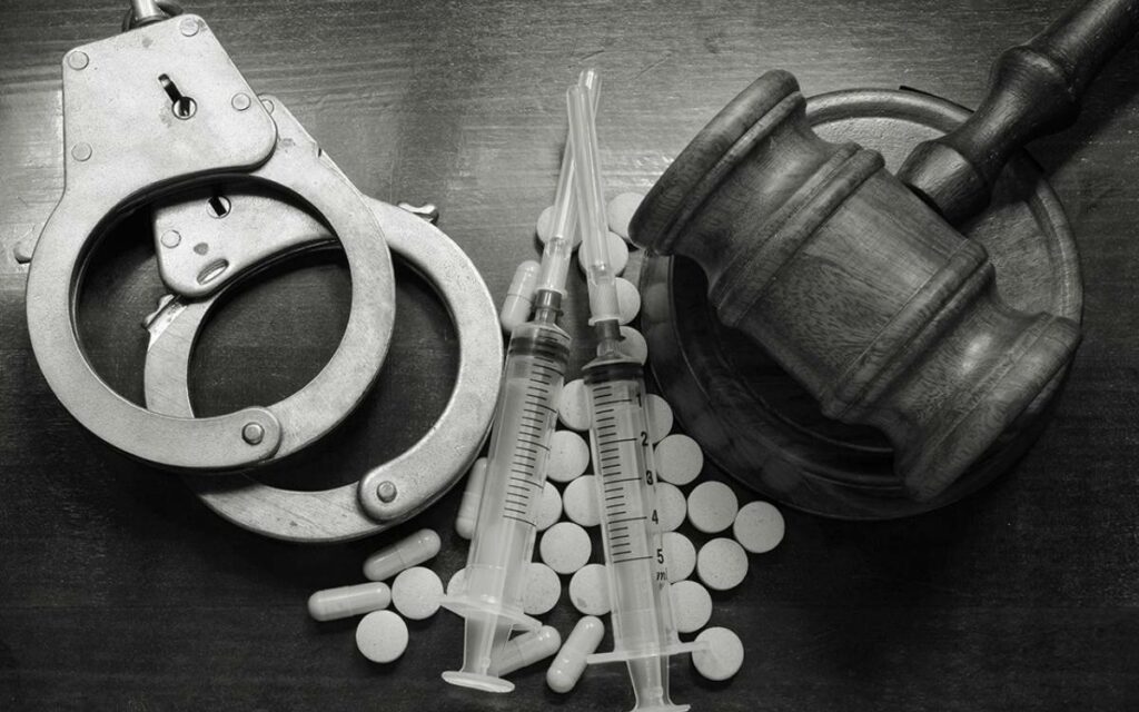 handcuffs, syringes, and a gavel