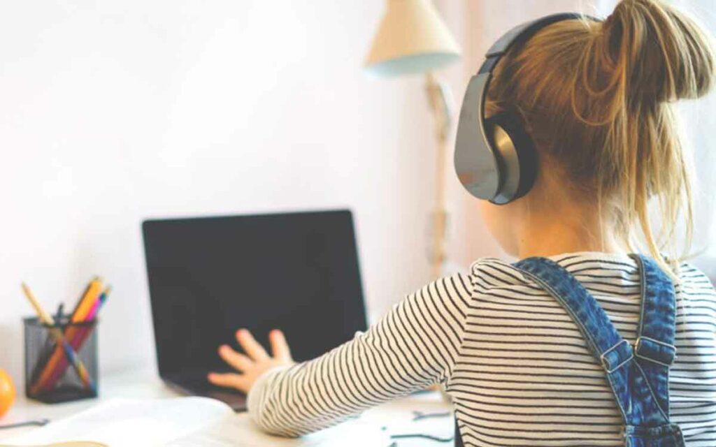 a child sitting in front of a computer