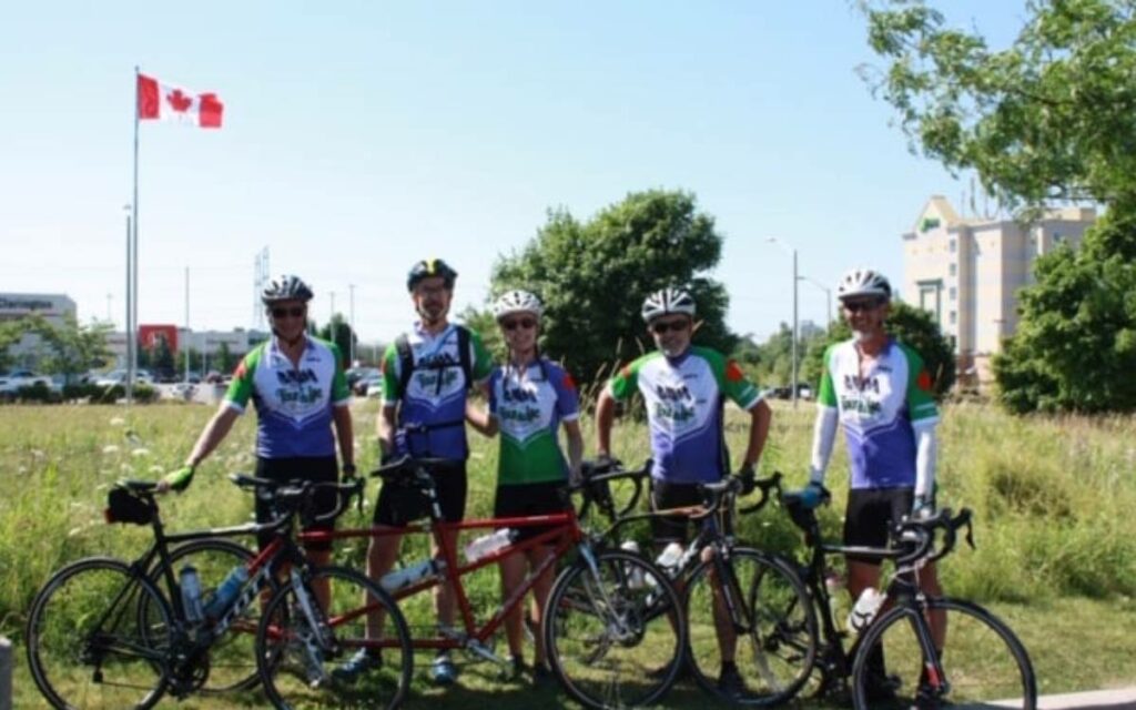 cyclists standing with their bikes