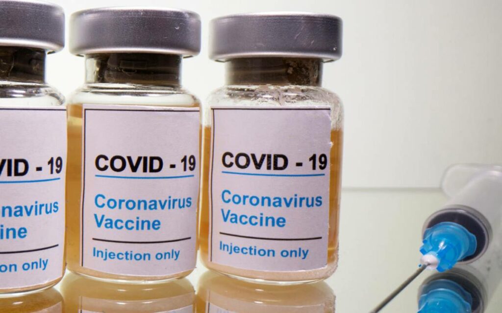 covid vaccine and a syringe