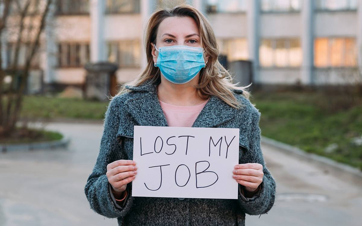 woman holding a "lost my job" sign