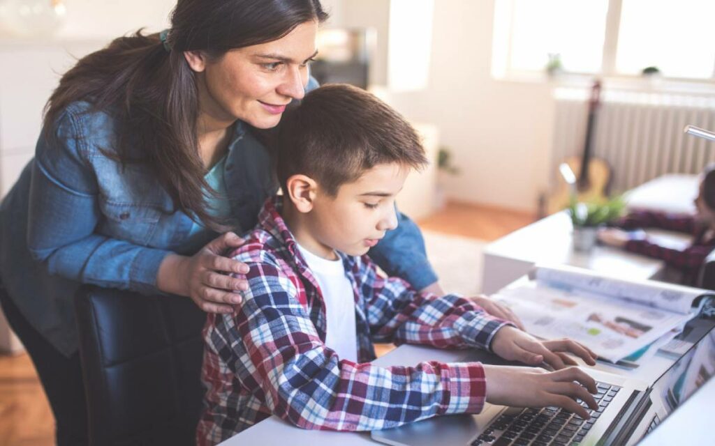 aprent and their child on a laptop