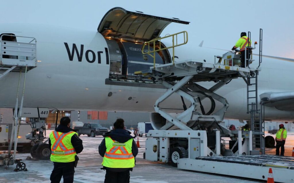 unloading the vaccine from a plane