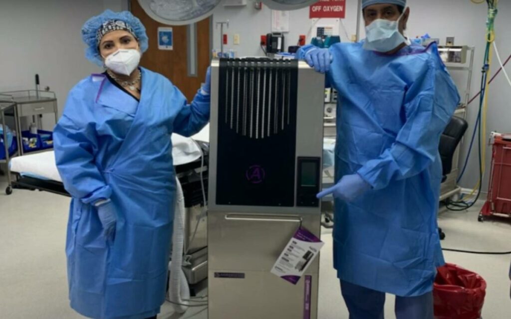 health care professionals holding an air decontamination system