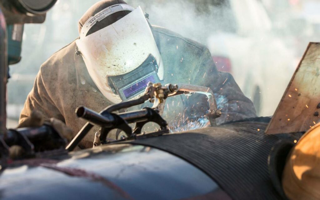 a welder working on a pipeline