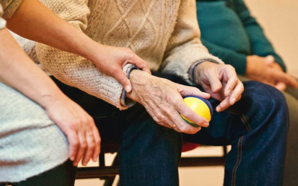 man holding a yellow ball in hand