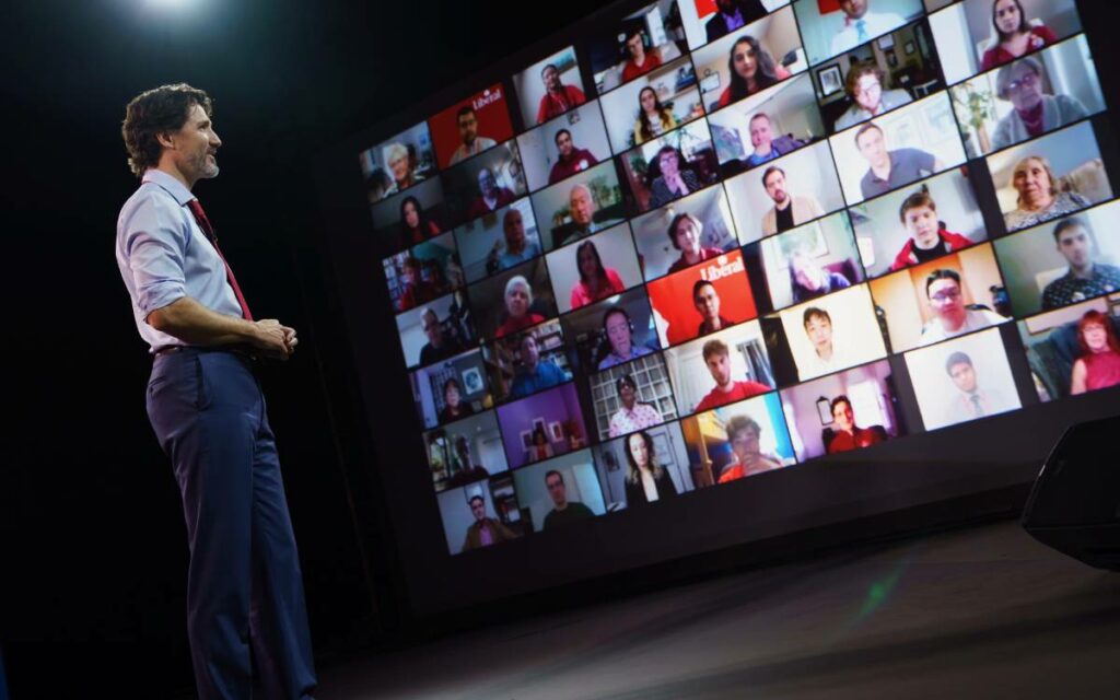 PM Trudeau in front of convention screens