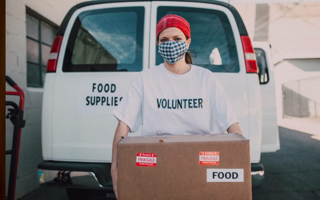 volunteer carrying a box