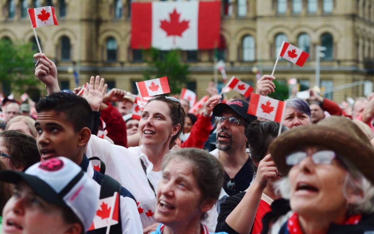 people waving Canadian flags