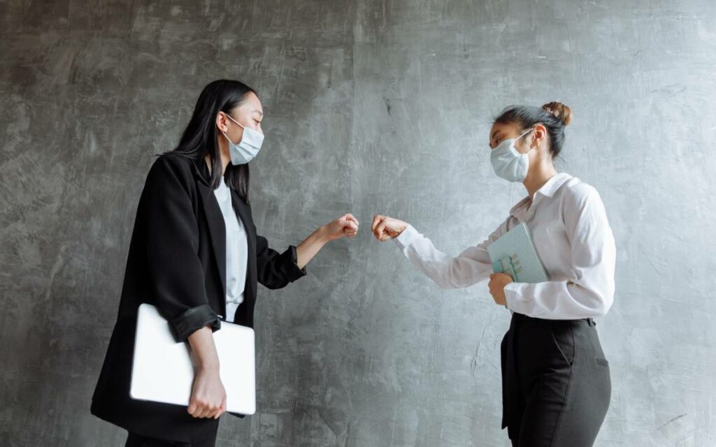 two people fist bumping