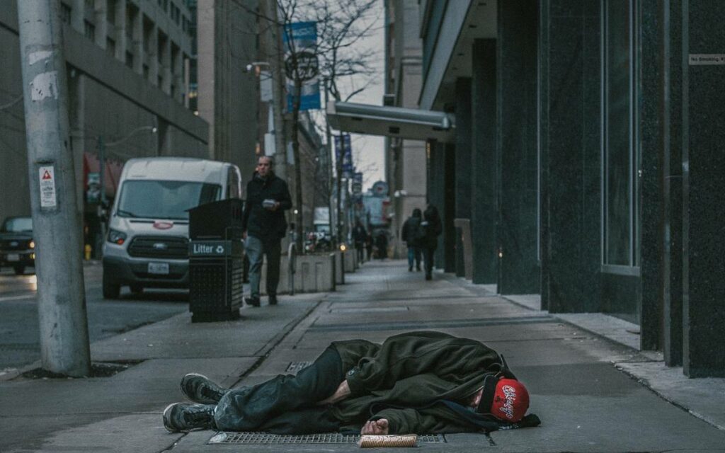 homeless person sleeping on the sidewalk