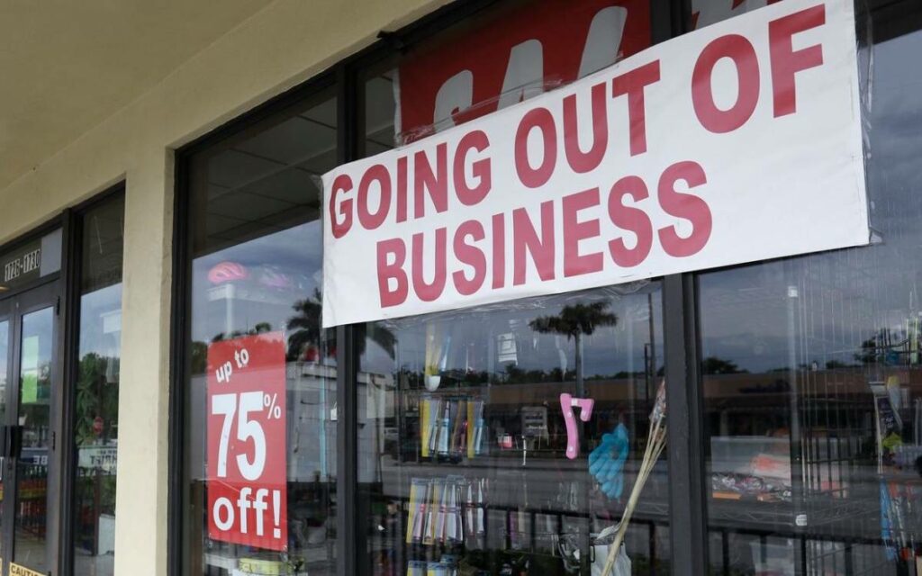 storefront with a going out of business sign in the window