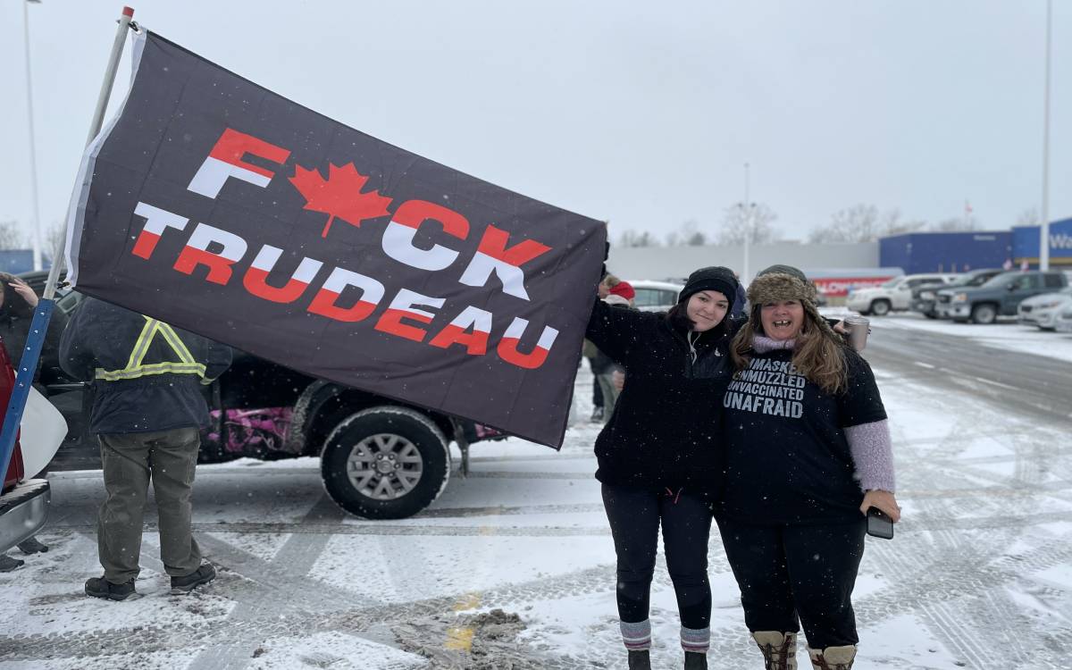 Two people holding an F Trudeau